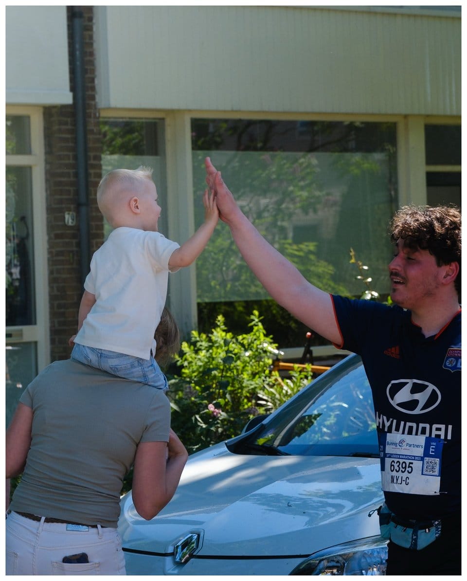 a man giving a high five to a child