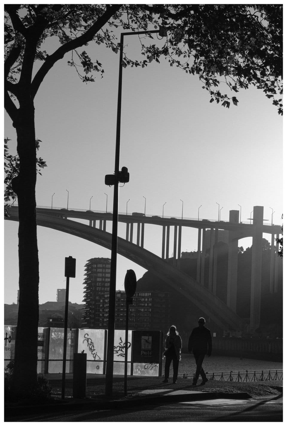 people walking under a bridge