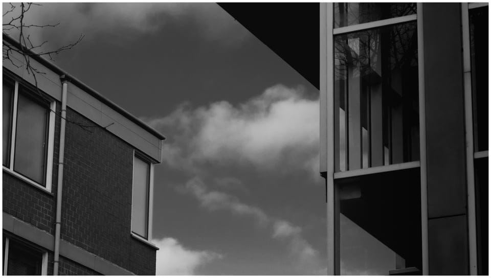Vie of the sky framed by two buildings. Photography in monochrome