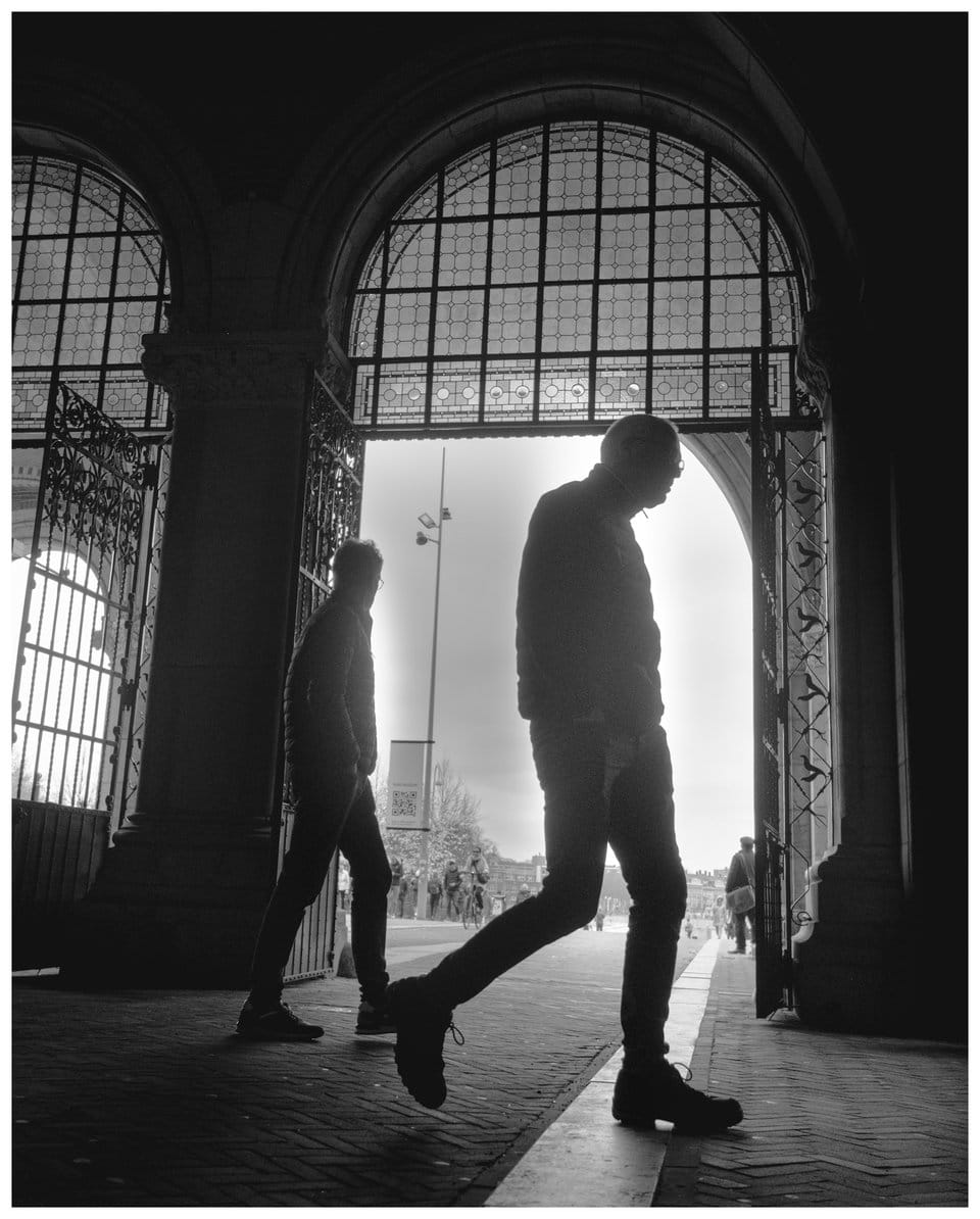 two men walking through an archway
